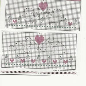 May include: Two cross-stitch patterns for fingertip towels. The top pattern features two bunnies with a pink heart between them. The bottom pattern is a repeat of the top pattern. The text "FINGERTIP TOWELS - Bunnies and Sheep" is at the top.
