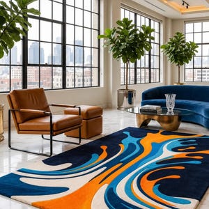 May include: A rectangular area rug featuring a bold, abstract pattern with fluid, wave-like shapes in vibrant orange, bright blue, and light blue, set against a deep navy blue and cream background, displayed on a white marble floor in a room.