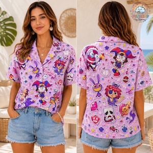 May include: A light purple short-sleeve button-down shirt featuring an all-over print of various cartoon characters, masks, and symbols. The shirt includes a small rectangular patch on the chest with the name Sophia printed in cursive script.