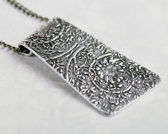 flower swirl design embossed pendant silver aluminium on silver or rhodium plated chain