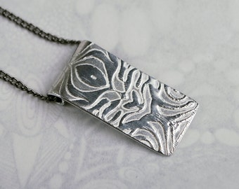 Swirl design embossed pendant silver aluminium on silver or rhodium plated chain