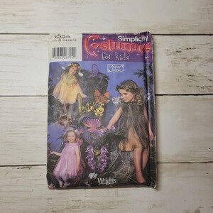 May include: A Simplicity Costumes for kids sewing pattern envelope featuring illustrations of three children in fairy-inspired outfits. The purple packaging displays the text Costumes for kids, Andrea Schewe, and Wrights, with a barcode and size A 3,4,5,6,7,8.