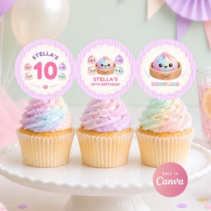 May include: Three cupcakes with rainbow-colored frosting topped with circular paper toppers featuring pastel purple stripes, scalloped edges, and illustrations of cute smiling dumplings with the text Stella's 10th Birthday and Dumpling.