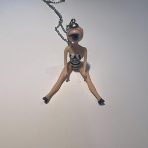 Sleepy blinking baby doll eye vintage mini Barbie doll necklace weird and whimsical