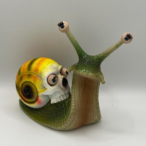 Weird and whimsical snail with blinking baby doll eyes