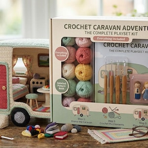 May include: A crochet caravan playset kit featuring a beige and mint green crocheted camper model, a box containing colourful yarn balls, crochet hooks, a pattern book, and small wooden figures. The box is labelled Crochet Caravan Adventure.