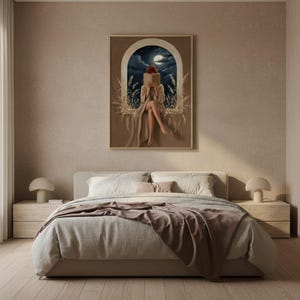 The moonlit reading print framed above a bed with linen bedding in a quiet neutral bedroom