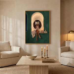 Emerald green reading nook art print on a warm plaster wall in a serene beige living room with two cream armchairs, brass candlesticks and a travertine coffee table by sheer curtains.