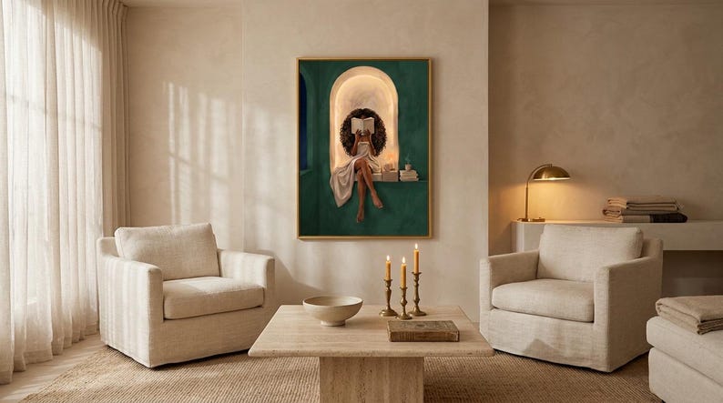 Emerald green reading nook art print on a warm plaster wall in a serene beige living room with two cream armchairs, brass candlesticks and a travertine coffee table by sheer curtains.