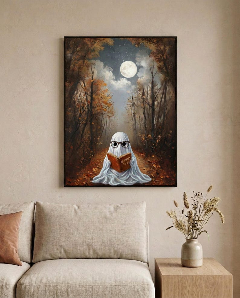 The autumn forest ghost reading print framed in a calm neutral living room above a linen sofa