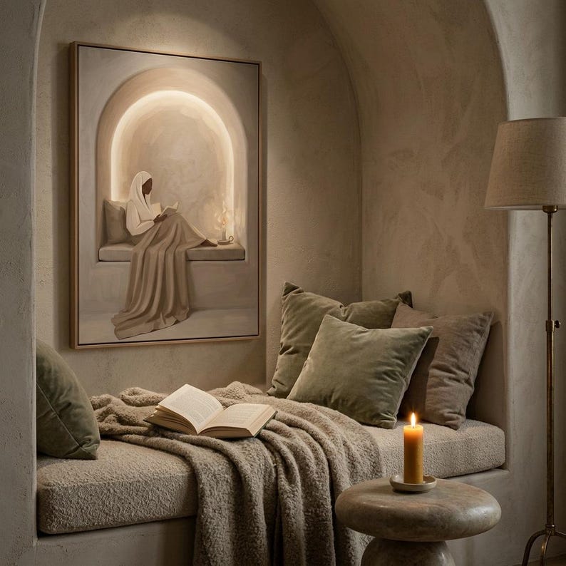 May include: A framed rectangular wall art piece depicting a figure in a white head covering and robe reading a book within an arched alcove. The artwork features soft beige and cream tones with a glowing light effect surrounding the central figure.
