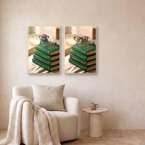 Two of the animals peeking over books prints framed in a reading corner beside a bouclé armchair with a chunky knit blanket and a ceramic cup on a side table.