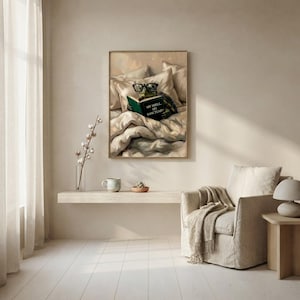 The tortoise reading print framed above a floating shelf beside an armchair with a draped throw and a sheer curtain in soft daylight