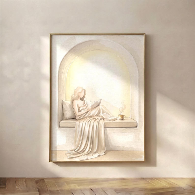 Woman reading in a quiet arched nook, neutral wall art print in a thin gold frame on a warm beige wall, soft plaster arch and draped linen, no mat.