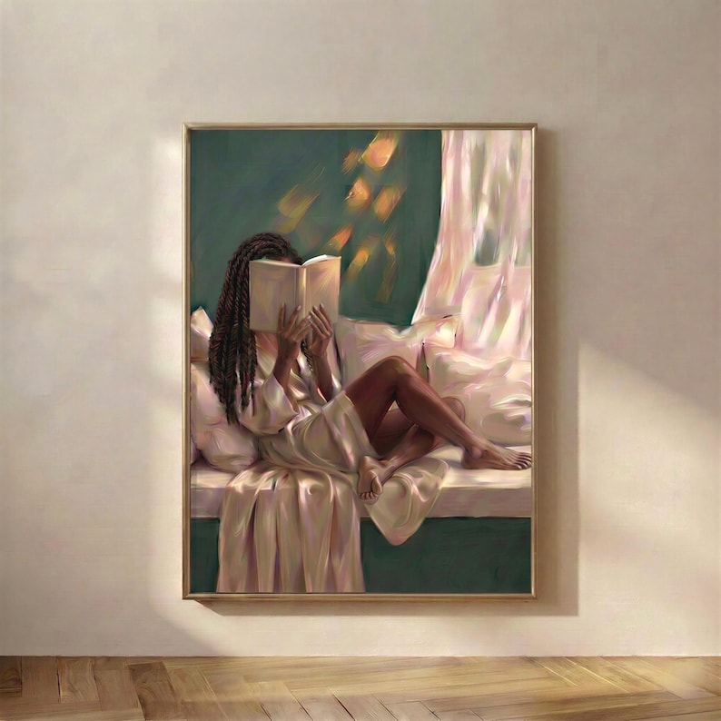Black woman with long braids reading on an emerald green window seat, wrapped in soft satin with a sheer curtain beside her. Emerald green printable wall art in a gold frame.