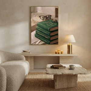 Wide view of a neutral living room with the turtle peeking over books print framed above a low sofa in soft daylight