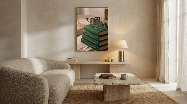 Wide view of a neutral living room with the turtle peeking over books print framed above a low sofa in soft daylight