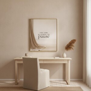 You Are Allowed to Pause styled in a restrained neutral office, hung in a thin gold frame with no mat. neutral printable wall art, minimalist home decor, Japandi style, calm living room decor, slow living digital download.