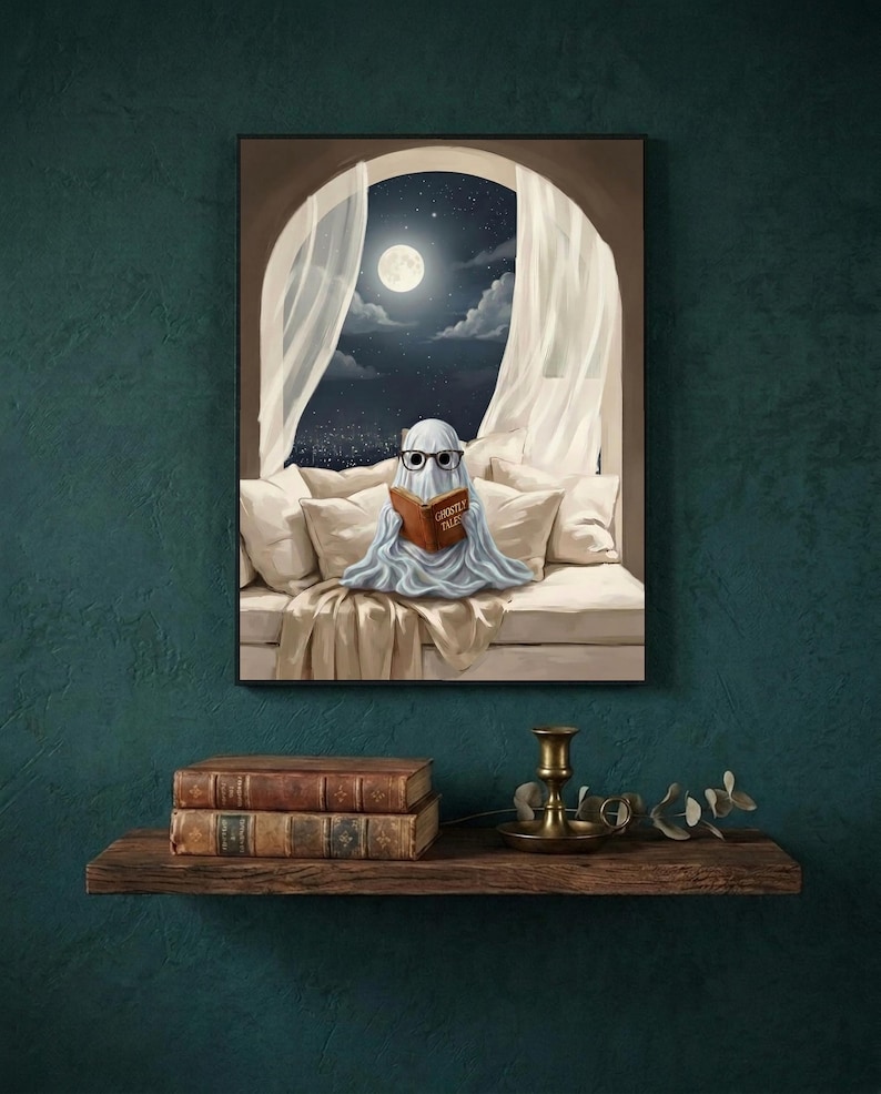 The moonlit bed ghost reading print framed on a deep teal wall above a narrow shelf with antique books and a brass candlestick