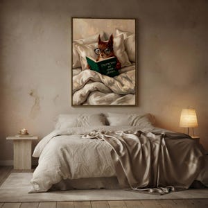The framed squirrel print above a bed with layered linen and a satin throw, lit by a small lamp on a pale nightstand
