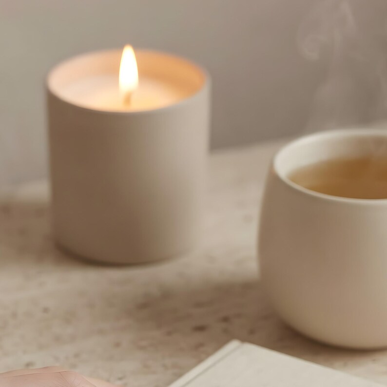 Close-up detail of evening journal ritual print showing lit candle and ceramic cup, soft beige minimalist still life