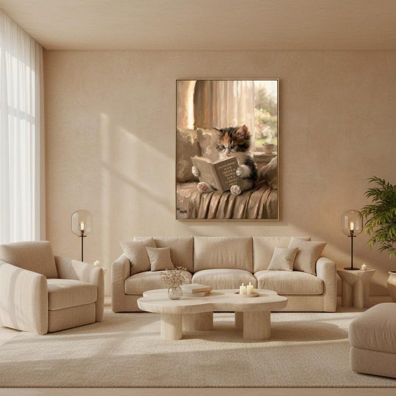 Cat reading wall art framed on a warm plaster wall in a calm light-filled living room with a cream linen sofa and a travertine coffee table