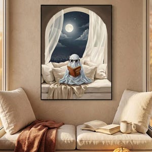 The moonlit bed ghost reading print framed above a cushioned window bench with a wool throw and a small pumpkin