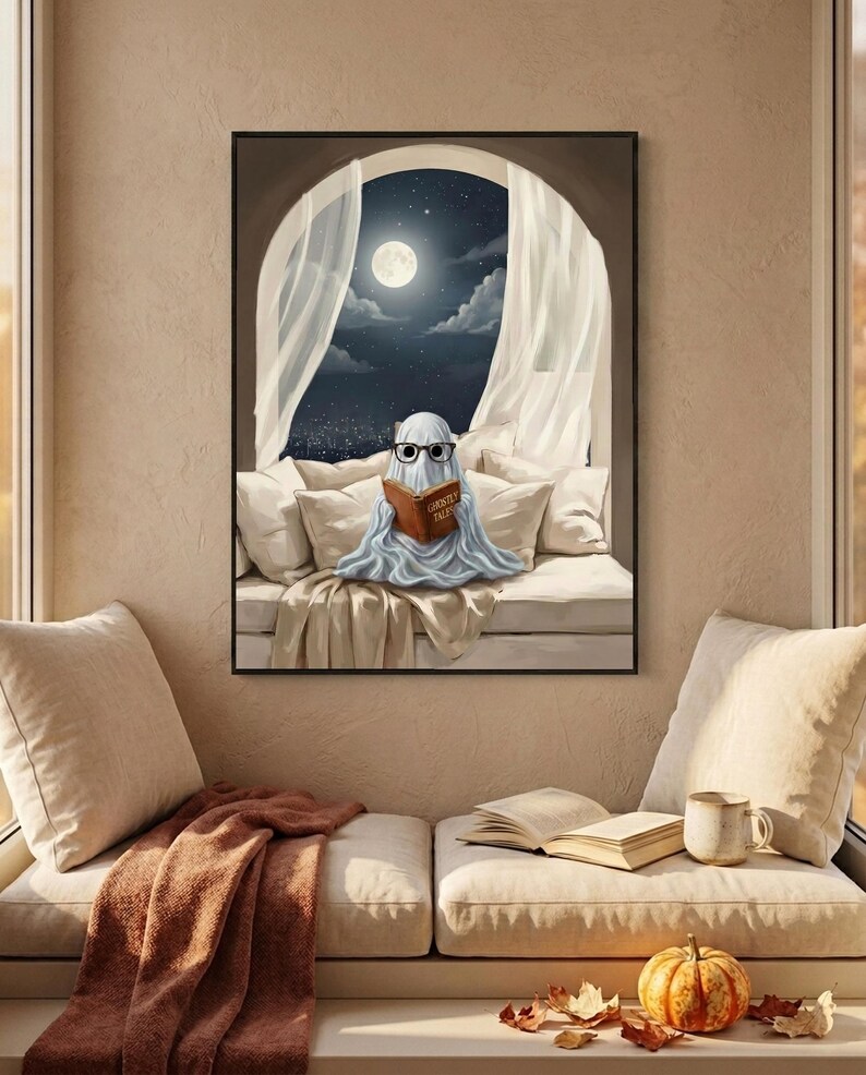 The moonlit bed ghost reading print framed above a cushioned window bench with a wool throw and a small pumpkin