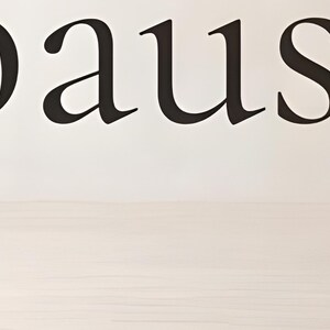 Close-up detail from You Are Allowed to Pause, a cropped fragment of the printable artwork: the word ‘pause’ set in a fine serif, the letters running past both edges of the frame, above a pale wood floor.