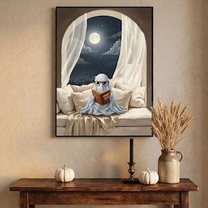 The moonlit bed ghost reading print framed above an entryway console styled for autumn with white pumpkins and dried wheat