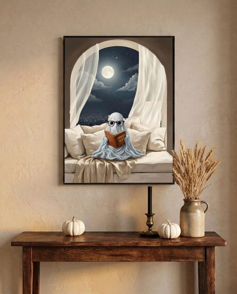 The moonlit bed ghost reading print framed above an entryway console styled for autumn with white pumpkins and dried wheat