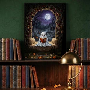 The graveyard arch ghost reading print framed and leaning on a dark wood library shelf against a deep green wall