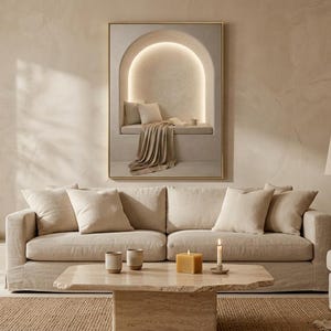 Wide living room view showing the reading nook wall art centered above a low sofa, gold frame, no mat.