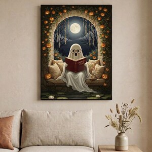 The pumpkin arch ghost reading print framed in a calm neutral living room above a linen sofa