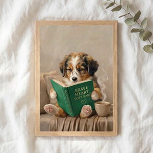 The puppy reading print in a thin natural oak frame lying on white linen with a sprig of eucalyptus