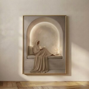Soft Plaster Nook print in a gold frame: a robed woman reading on a bench inside a warmly lit arched alcove, a lit candle in a chamberstick beside her.