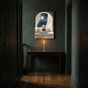 The moonlit bed ghost reading print framed alone in a dim charcoal-green hallway above a console with a single lit candle