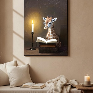 May include: A framed wall art print featuring a giraffe wearing round glasses, sitting behind a stack of dark books with an open book on top. A tall, thin black candlestick with a lit white candle stands to the left against a dark brown background.