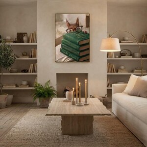 Wide view of a neutral living room with the squirrel peeking over books print framed above a low sofa in soft daylight