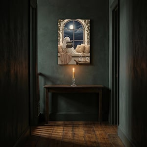 The window seat coffee ghost reading print framed alone in a dim charcoal-green hallway above a console with a single lit candle
