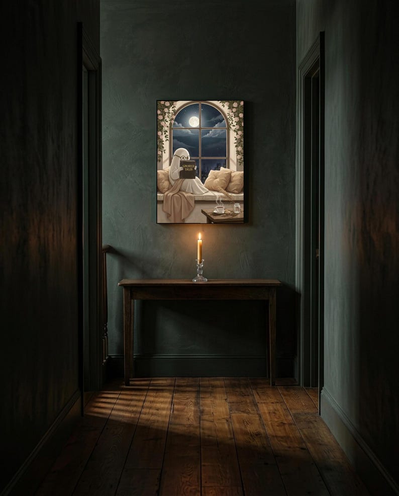 The window seat coffee ghost reading print framed alone in a dim charcoal-green hallway above a console with a single lit candle