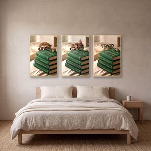 Three of the animals peeking over books prints framed above a bed made up in rumpled oatmeal linen, beside a pale oak nightstand with a cream mug.