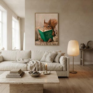 Squirrel reading wall art framed on a warm plaster wall in a calm light-filled living room with a cream linen sofa
