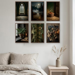 Six walnut framed prints hung as a three by two gallery wall above a linen bed on a pale wall: a gothic window hall, a moonlit lake, a woven basket of pears by a doorway, a potted fern on a sill, a vaulted ceiling, and dried poppy heads on paper