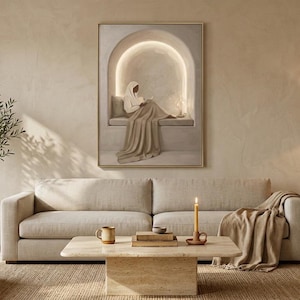 May include: A framed wall art print depicting a figure sitting in a glowing arched alcove, displayed above a beige sofa in a living room with a coffee table, a floor lamp, a potted olive tree, and a textured rug in neutral earth tones.