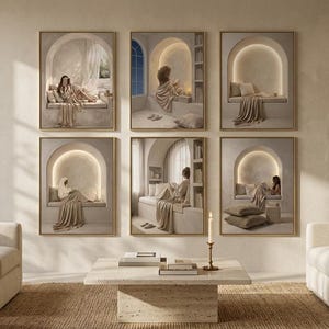 Wide view of the six-print beige reading nook gallery wall in a living room, between two cream armchairs and a sofa, with a brass candlestick on a travertine table.
