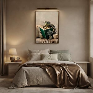 Tortoise reading art print framed on a textured plaster bedroom wall above linen bedding in soft morning light