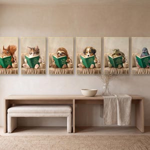 All six reading animal prints hung in a single long row in gold frames above a pale oak console table, with a bouclé bench beneath and a jute rug on the floor