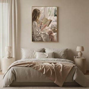 Bedroom with linen bedding in soft neutrals and the woman reading art print in a gold frame above the headboard