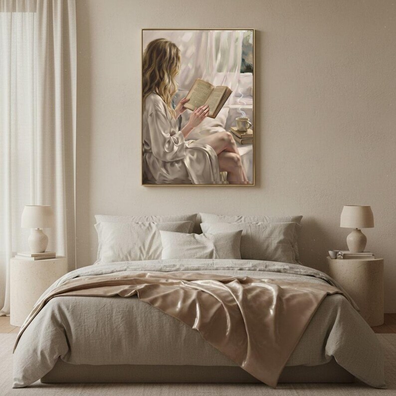Bedroom with linen bedding in soft neutrals and the woman reading art print in a gold frame above the headboard
